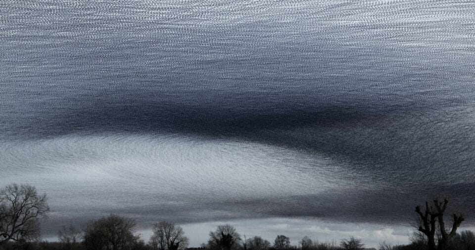 a dusk timelapse photo of a landscape with a dramatic murmuration of starlings