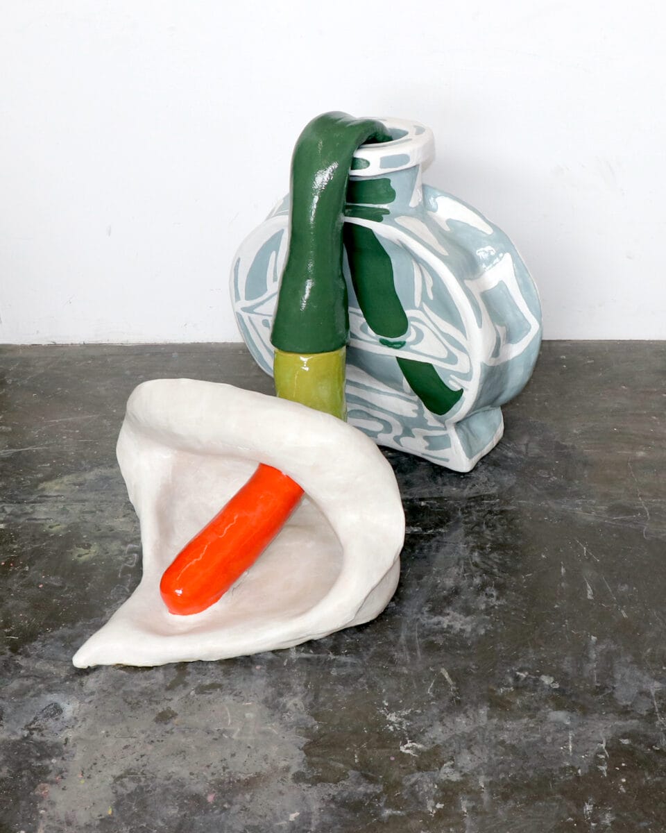 a sculpture of a drooping calla lily sitting in a bottle