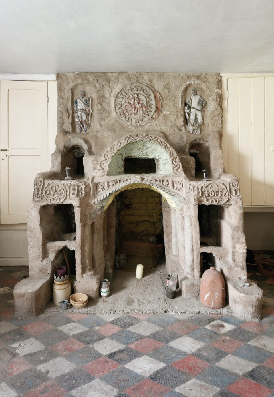 the interior of Ron Gittins' apartment in Birkenhead, England, featuring a very ornate, hand-sculpted fireplace with numerous niches