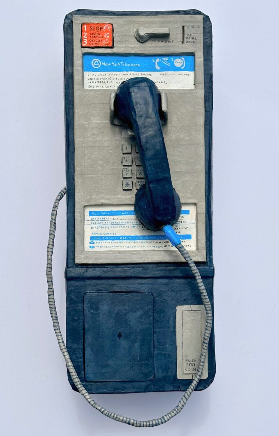 a paper mache sculpture of a payphone