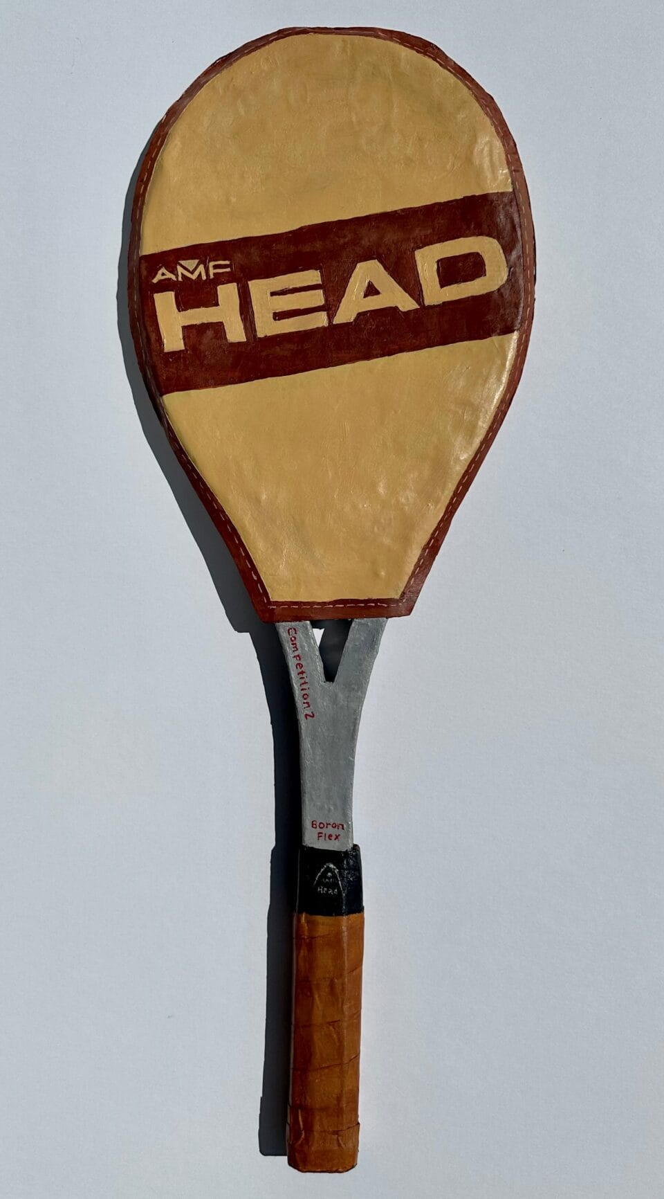 a paper mache sculpture of a tennis racket