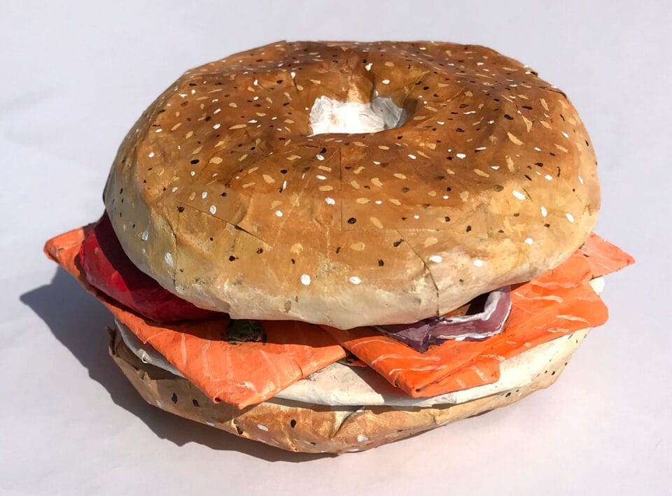 a paper mache sculpture of a bagel with lox