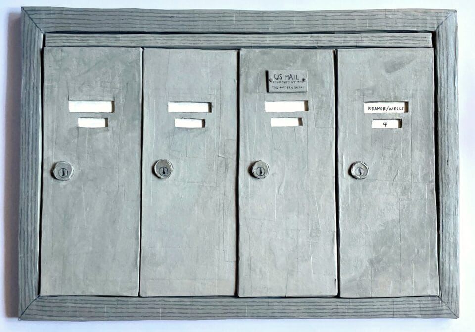 a paper mache sculpture of four metal mailboxes