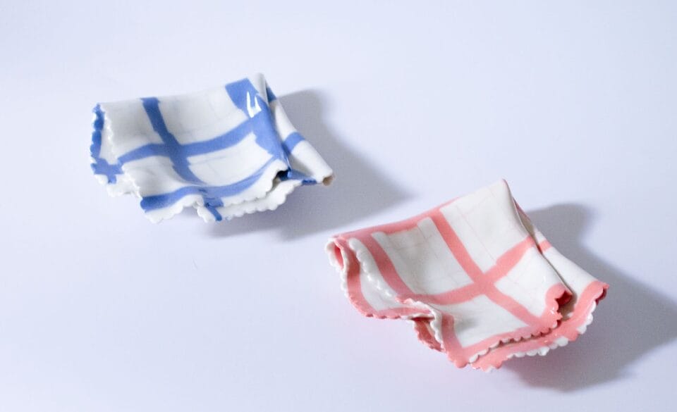 two small ceramic dishes that appear to be made of folded kerchiefs