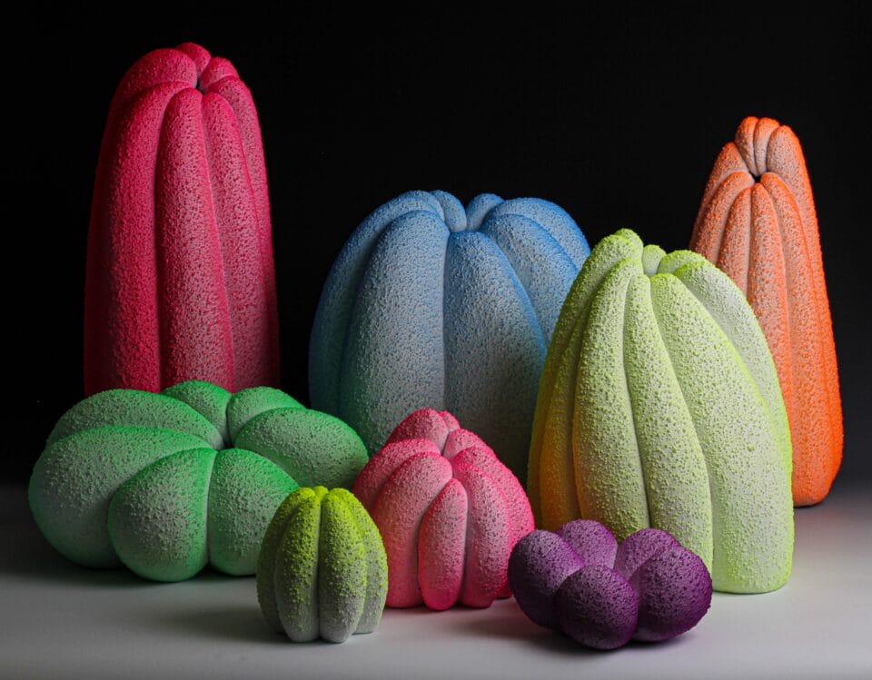 a group of seemingly glowing or fluorescing vase sculptures in different colors and globular, gourd-like shapes