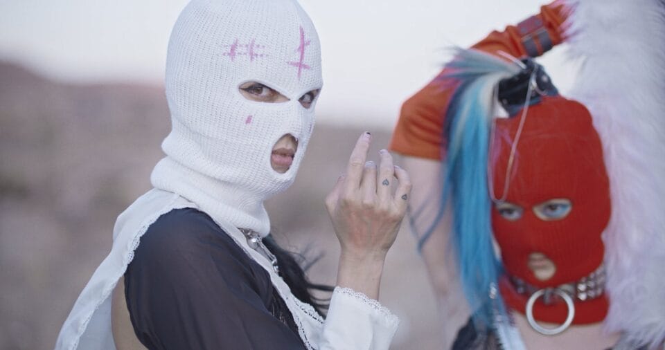 the artist in a white balaclava during "Putin's ashes"