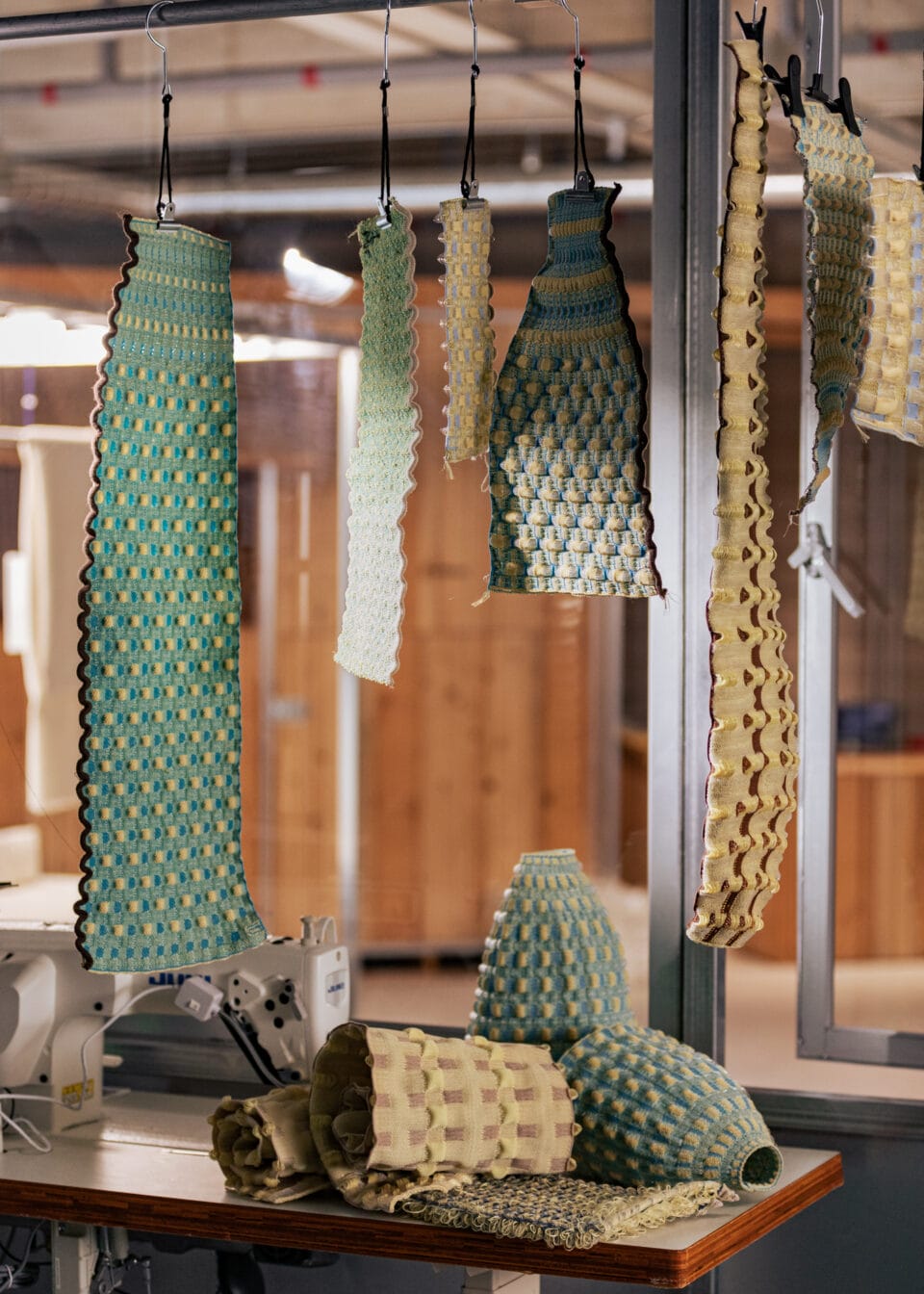 woven strips of fabric hanging from a wire, used to for light shades