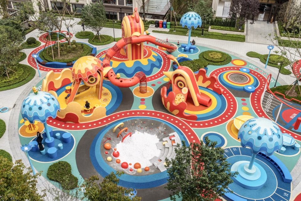 a colorful outdoor park with playground equipment built to look like fantastic characters