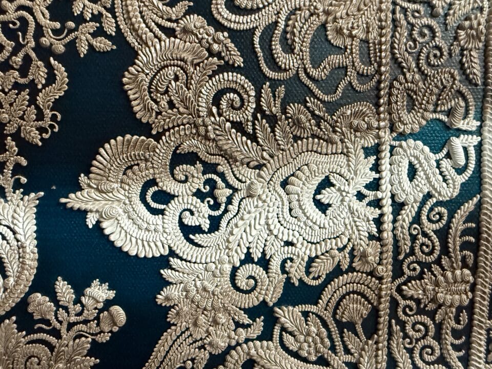 a detail of a hyperrealistic oil painting of a crinkled ornamental carpet