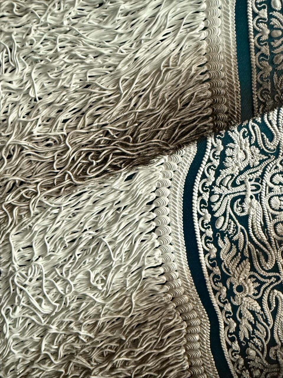 a detail of a hyperrealistic oil painting of a crinkled ornamental carpet