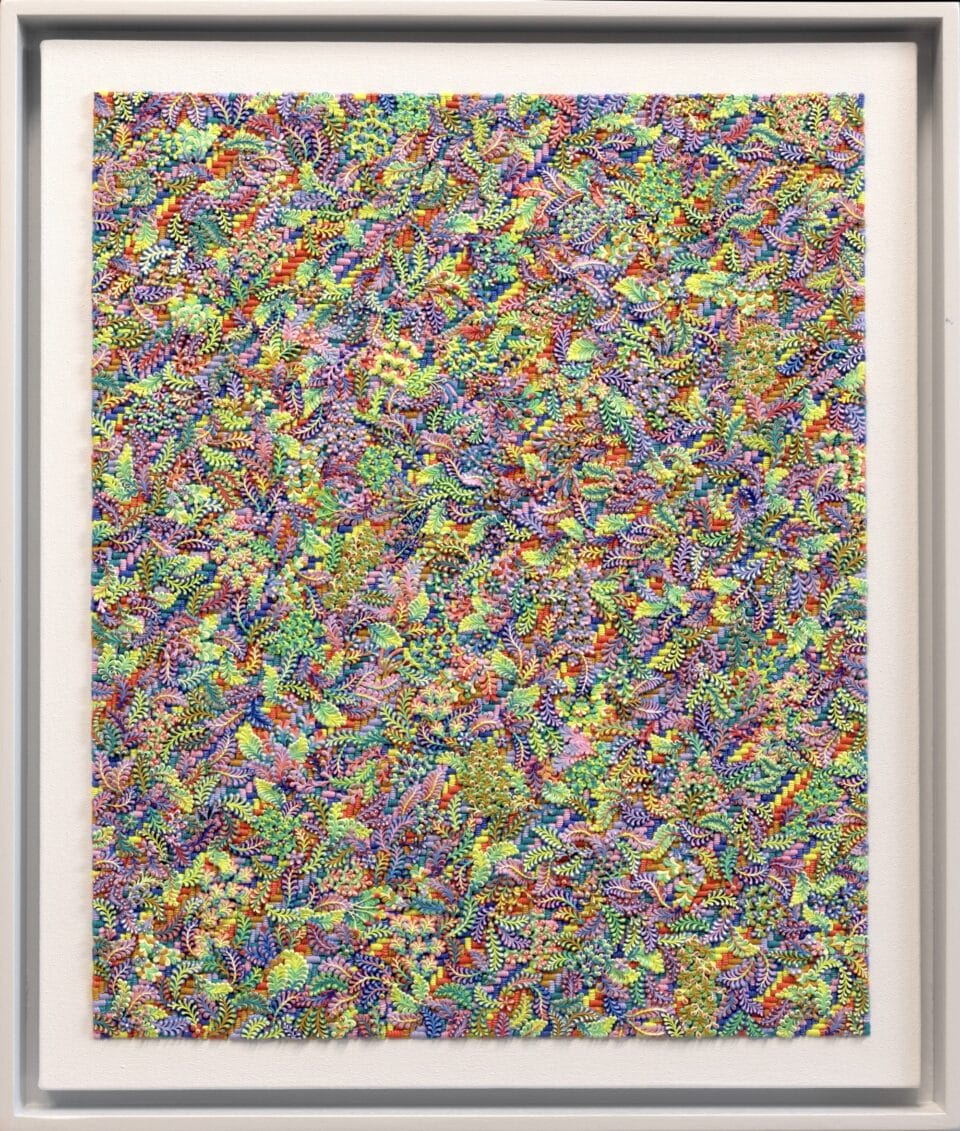 a framed, highly textured oil painting in a multi-colored floral pattern