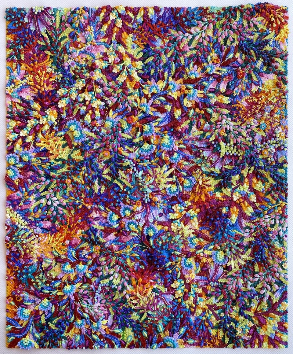 a highly textured oil painting in a multi-colored floral pattern