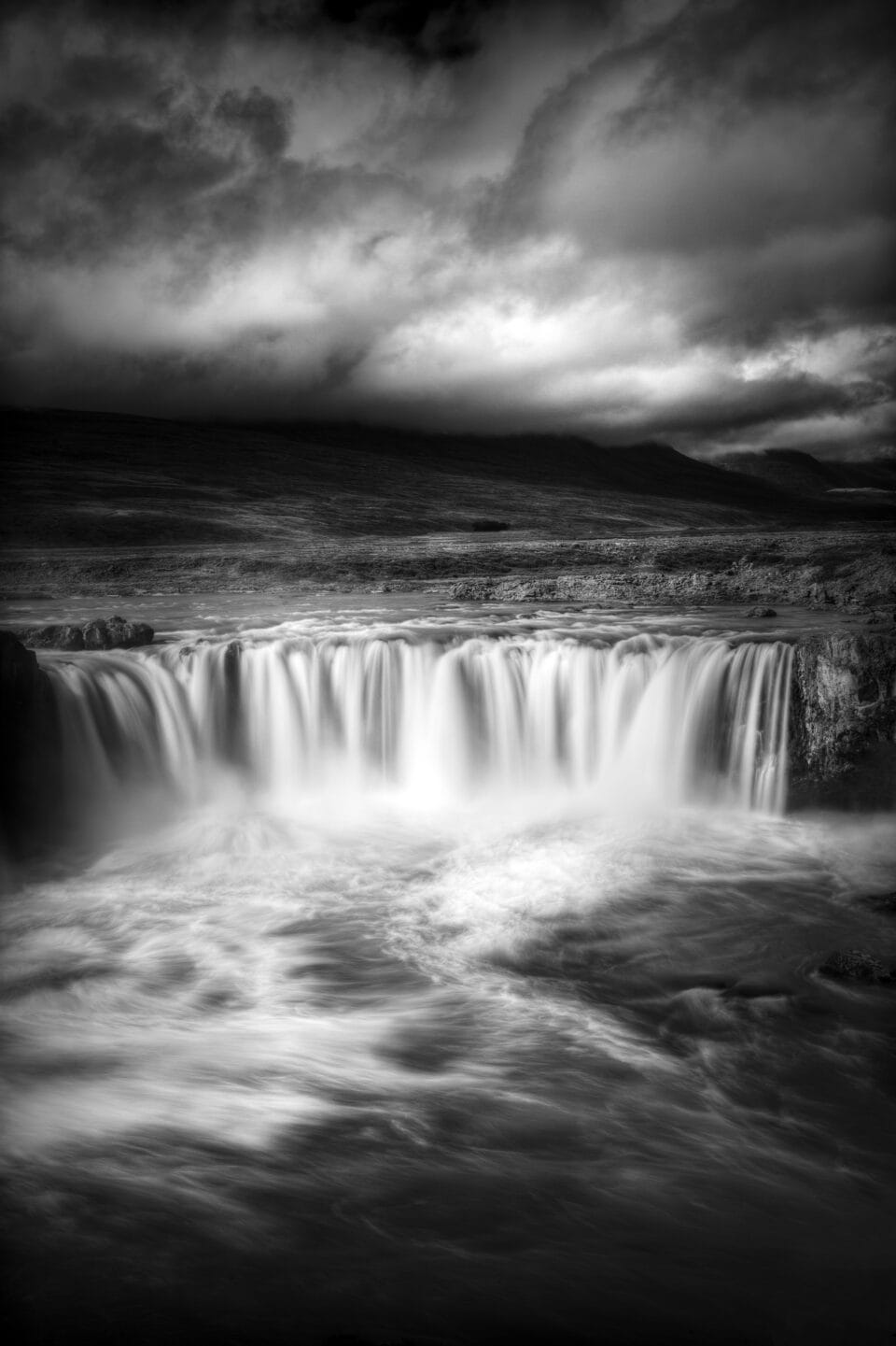 a black-and-white photograph of a waterfall in Iceland