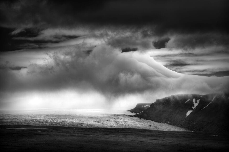 a black-and-white photograph of the shoreline in Iceland