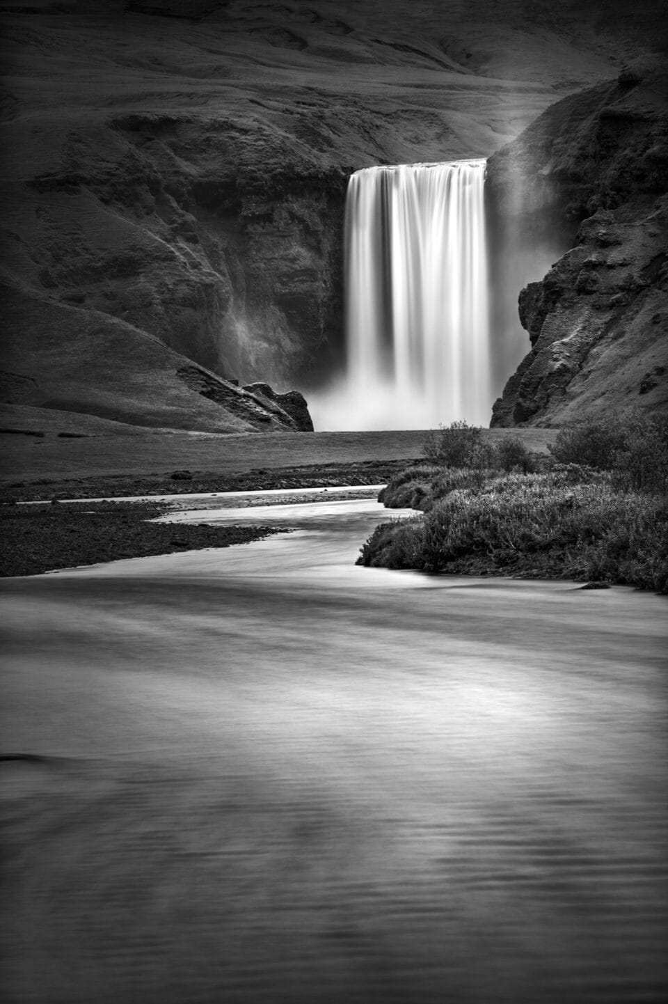 a black-and-white photograph of a waterfall in Iceland