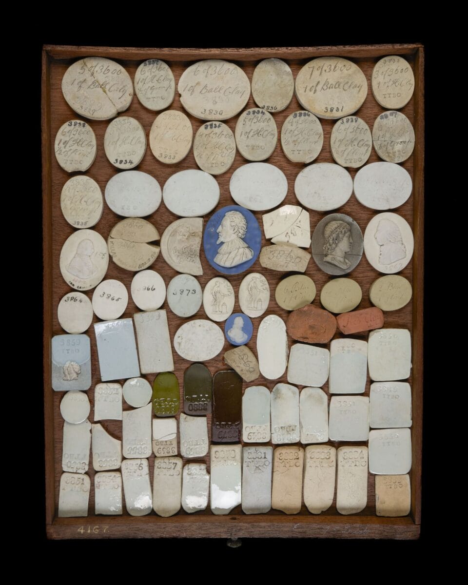 a tray of various shapes of ceramic pieces glazed with different colors